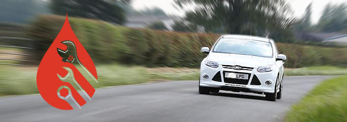 White ford sedan being driven through the country side with mechanical logo appearing in the image. Farm gates and Hedges displaying in back ground.